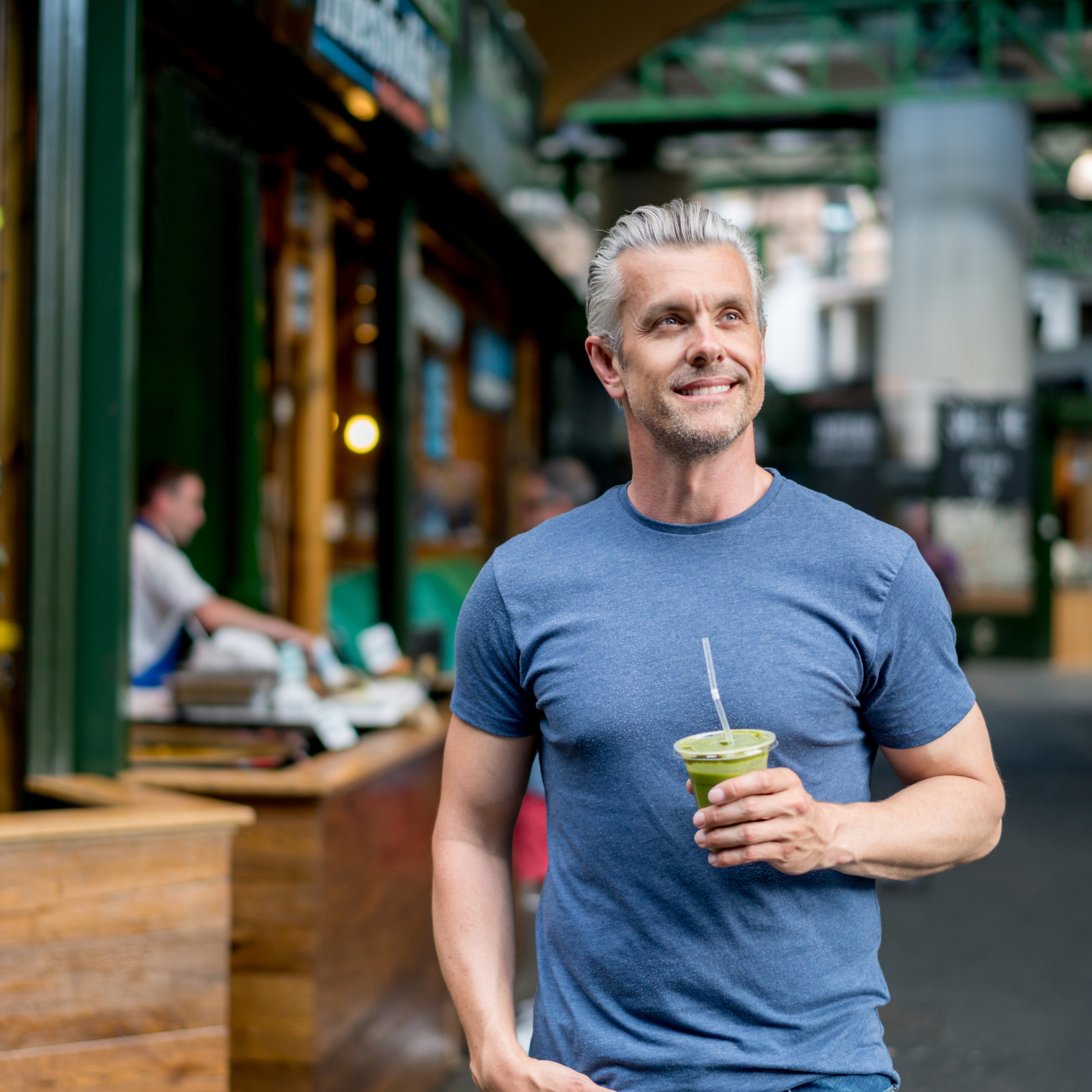 Healthy man with green smoothie
